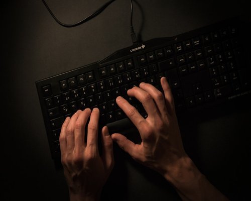 Hands stretching above a keyboard